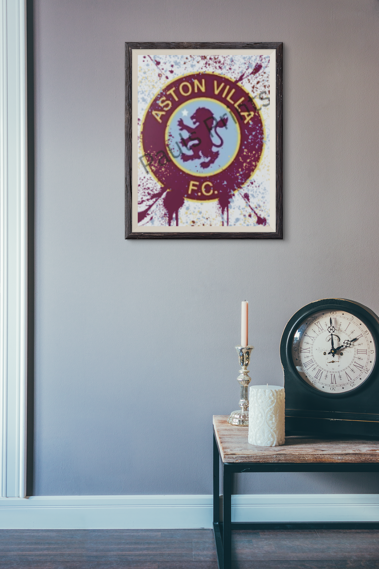 Aston Villa FC art in black frame hung on light purple wall above vintage clock and candle decor.