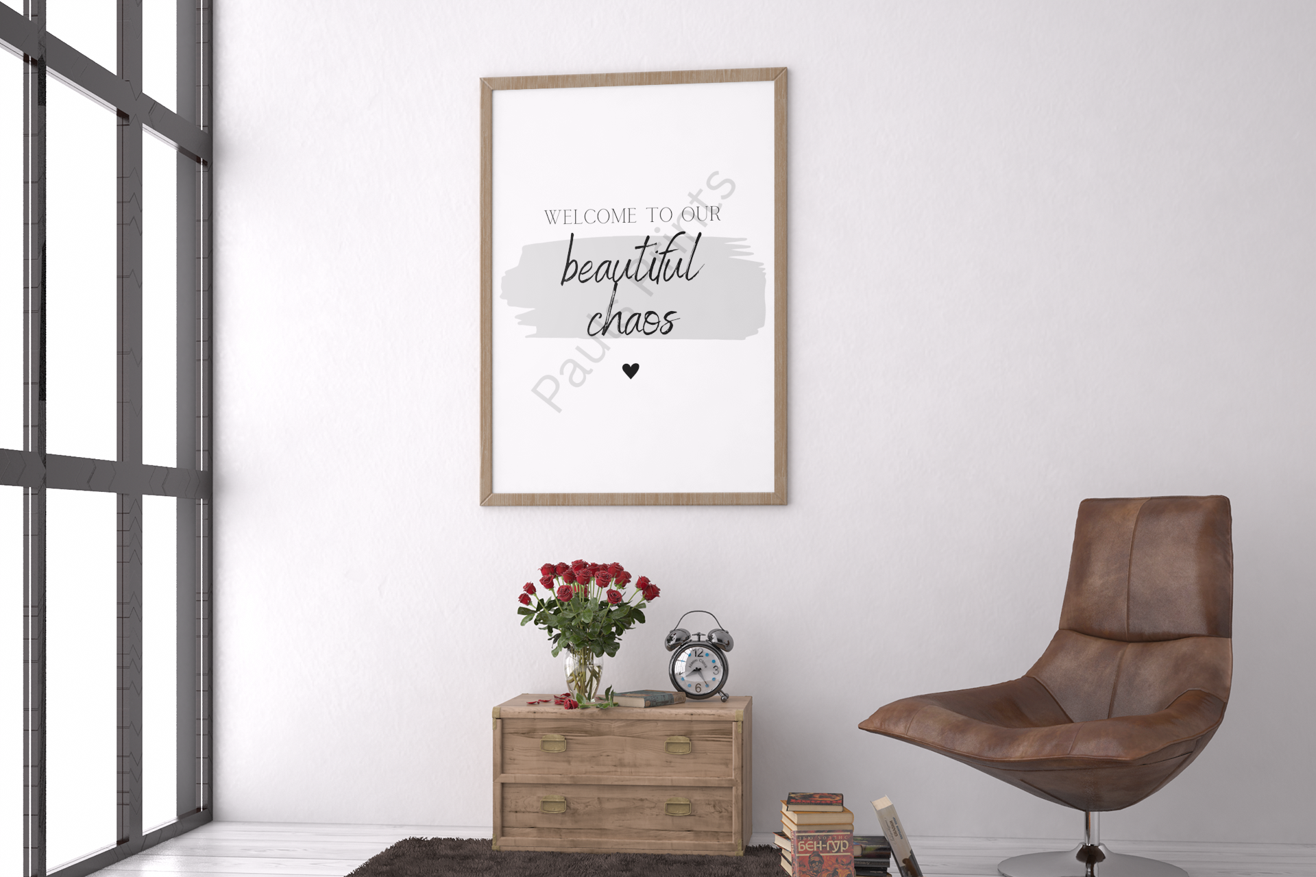 Framed quote “Welcome to our beautiful chaos” beside brown leather chair and wooden side table with red roses.