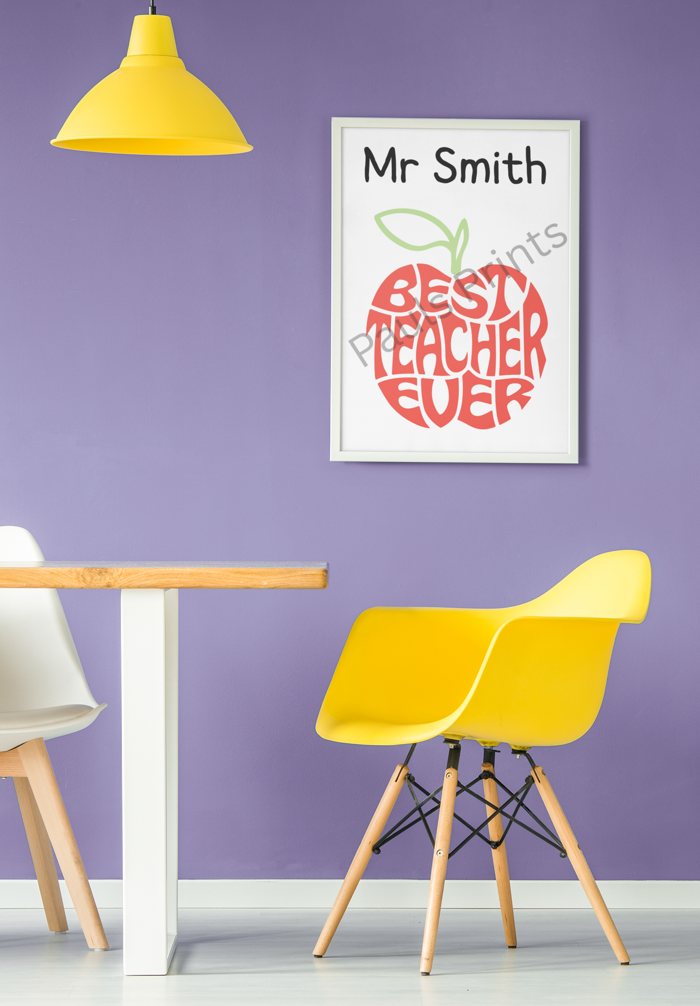 Framed Best Teacher Ever apple print with name personalisation, hung on purple wall next to yellow chair and pendant light.