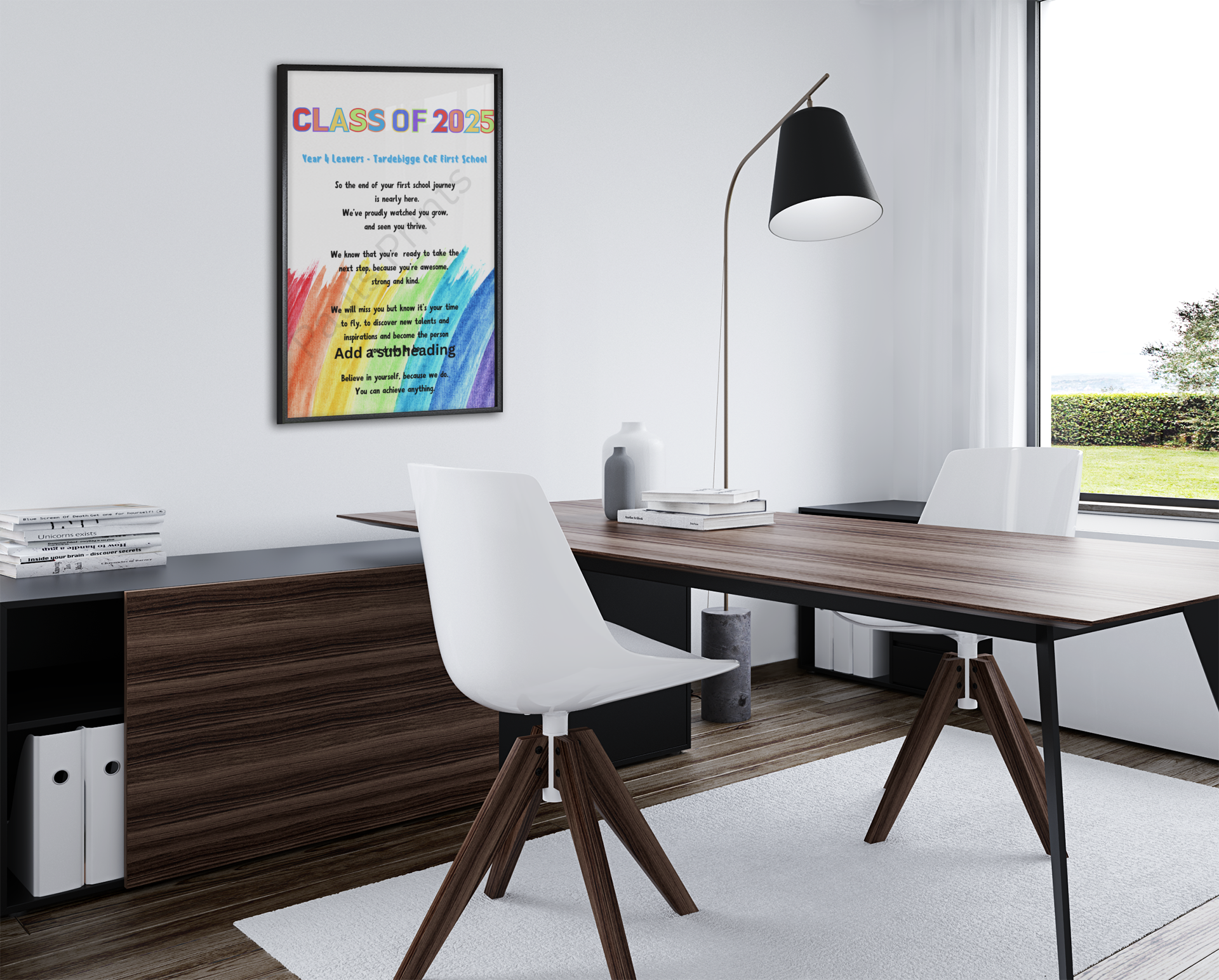 Framed “Class of 2025” Year 4 leavers rainbow poem hung on an office wall above a modern desk with chairs and books.