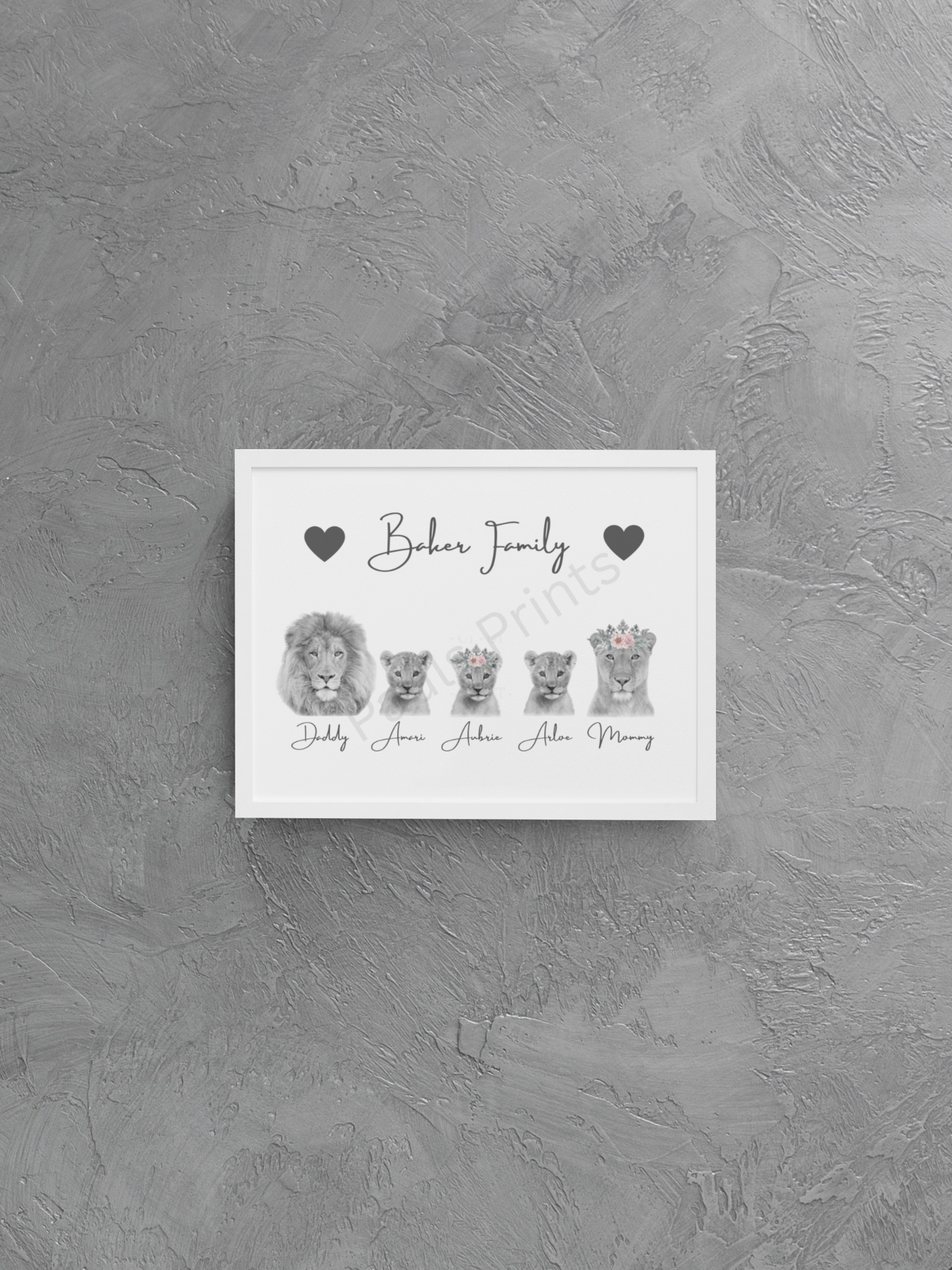 Lion family print with customisable names and heart icons, presented in a white frame on a textured grey wall.