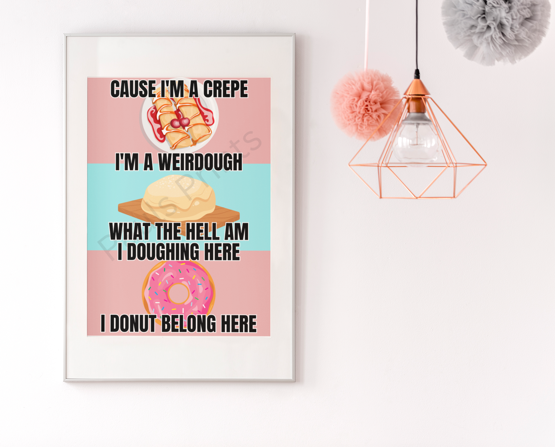 Playful food pun poster featuring illustrations of a crepe, dough, and donut, framed in white and displayed beside pastel hanging pom-pom decor.