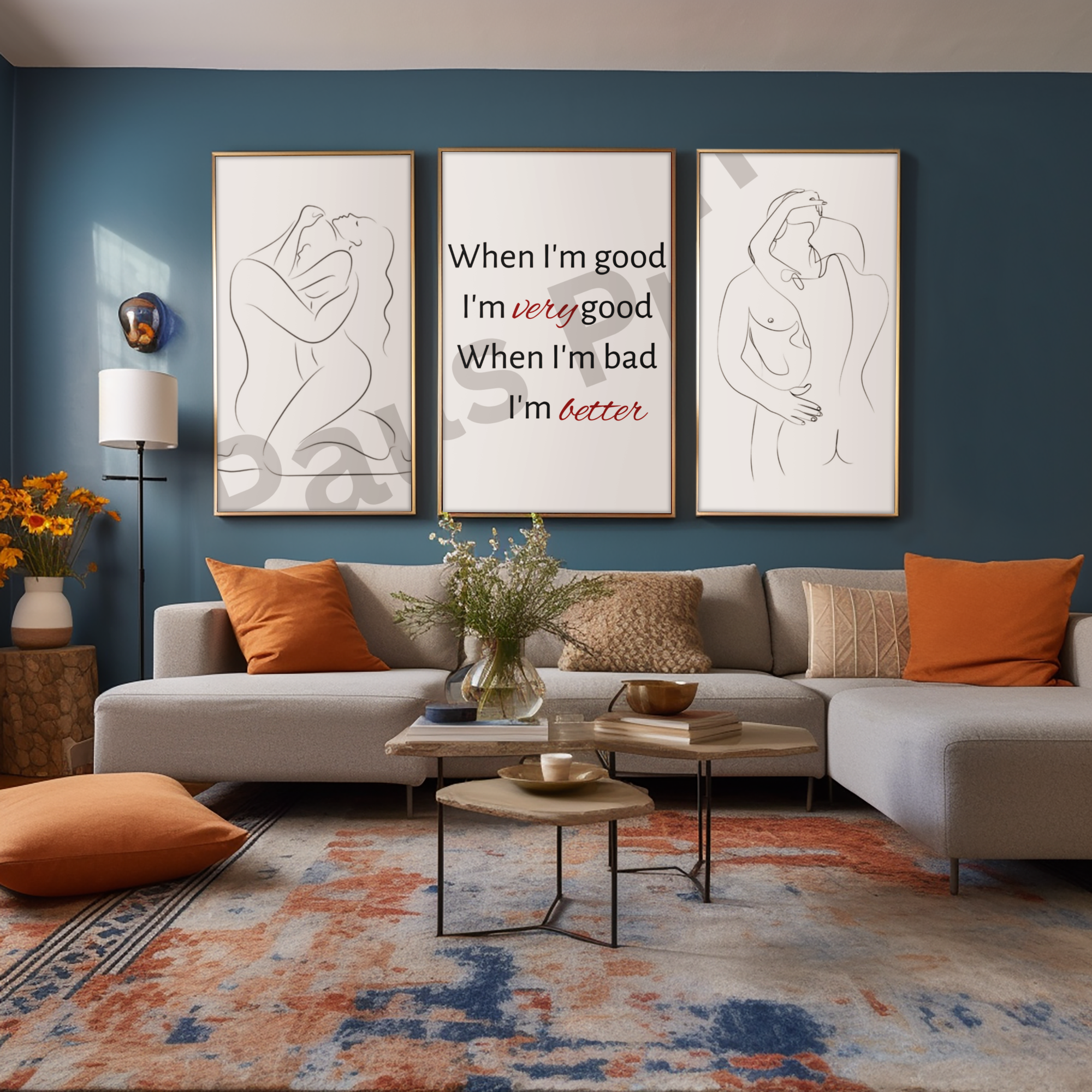 Statement trio of prints featuring empowering quote and line-drawn nudes mounted on a deep blue wall above a stylish grey sectional sofa with orange accents and a patterned rug.