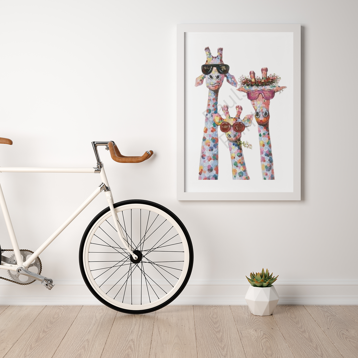 Giraffe family artwork in a white frame hung above a bicycle, with a small succulent plant on the floor in a minimalist room.