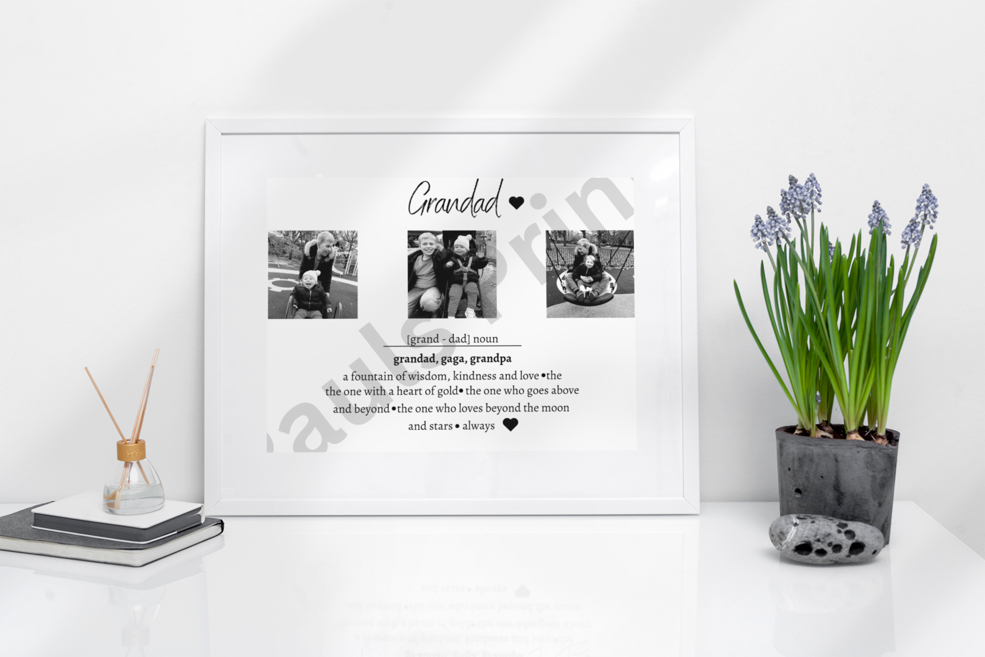 Elegant Grandad definition print in a white frame on a glossy white desk, styled with purple flowers and minimal accessories