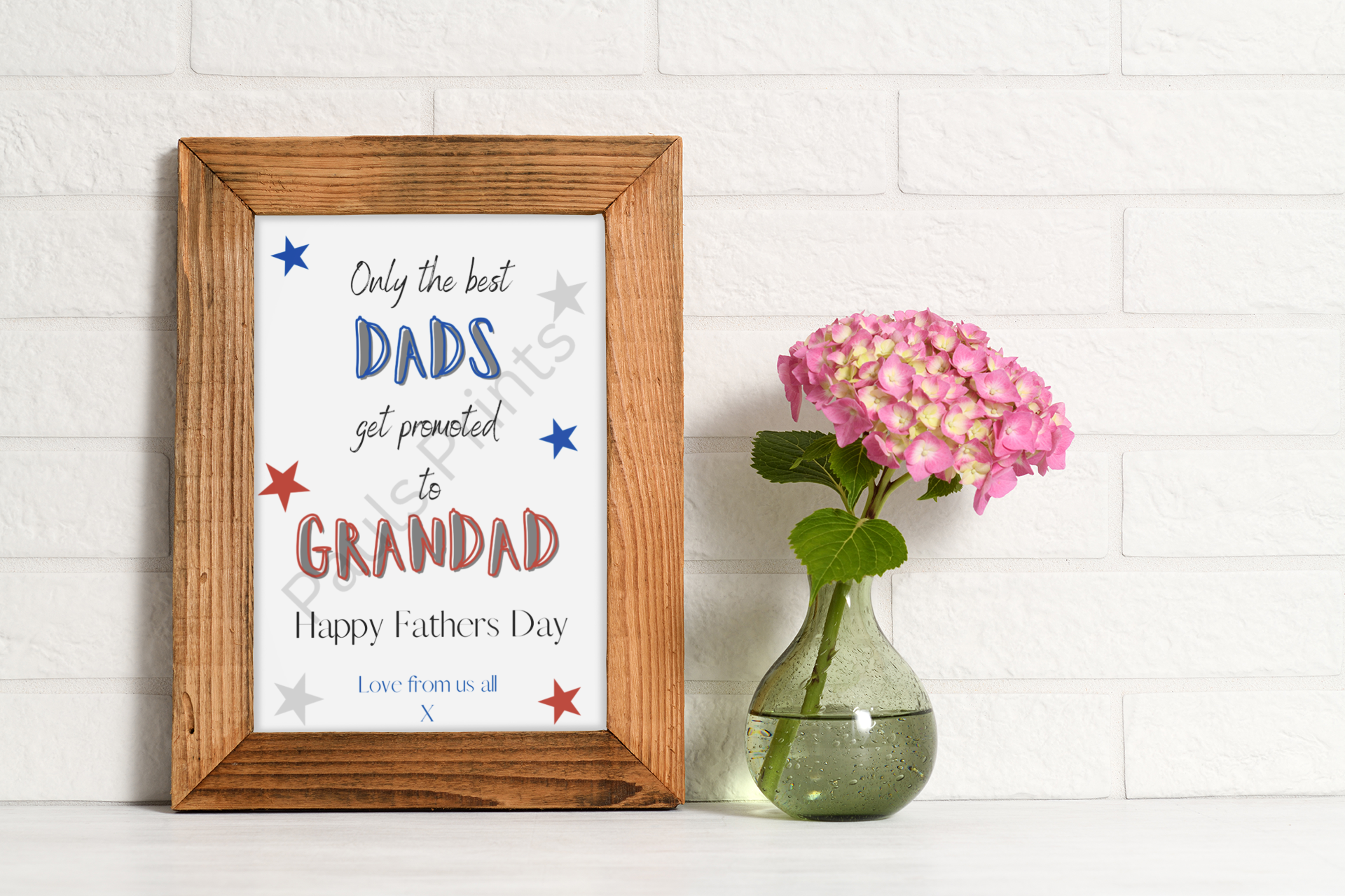 Framed Grandad Father's Day print on white brick background with wooden frame and pink hydrangea in glass vase.