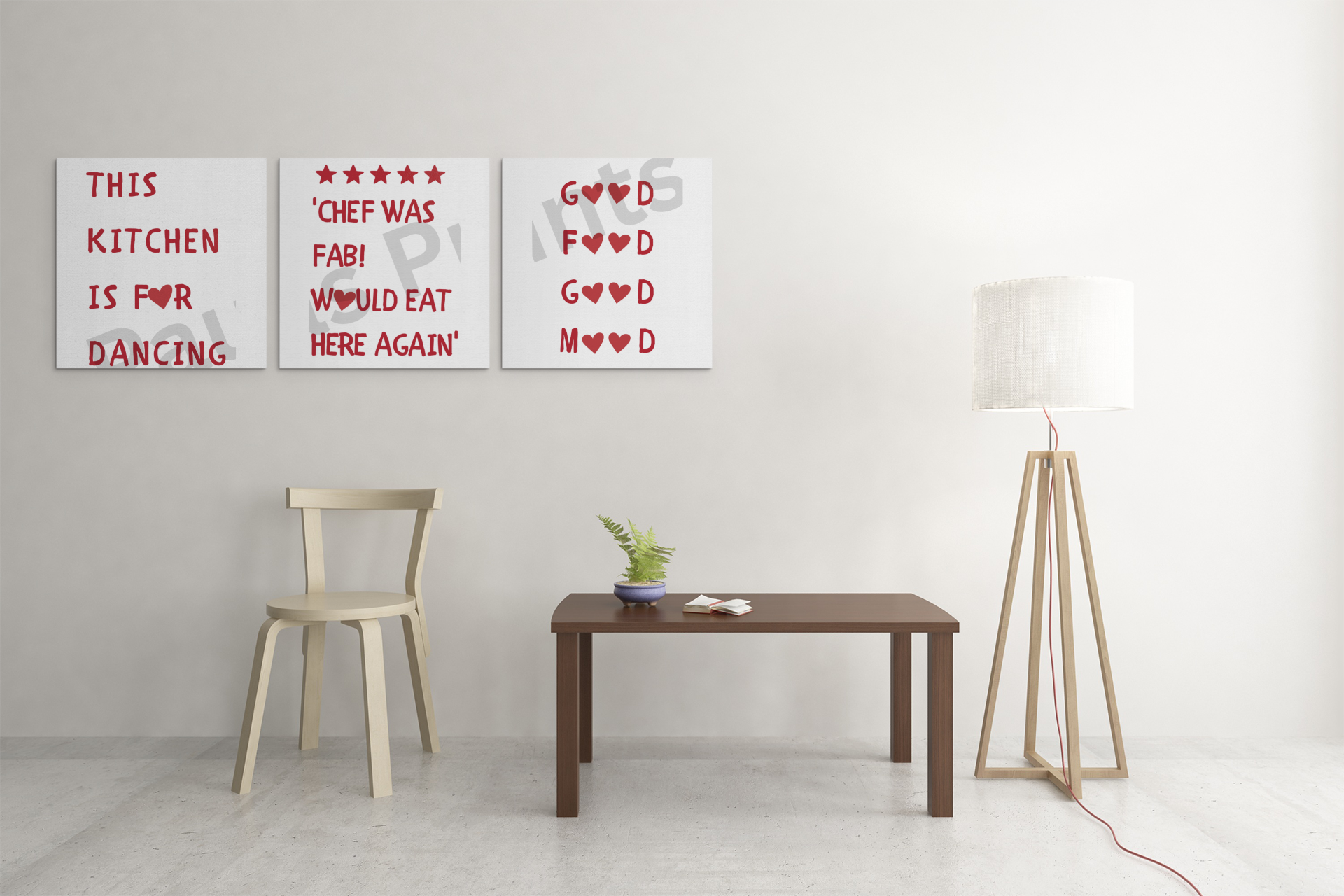 Minimalist kitchen wall art set with playful red text and heart shapes on white backgrounds, hung above a wooden chair and coffee table.