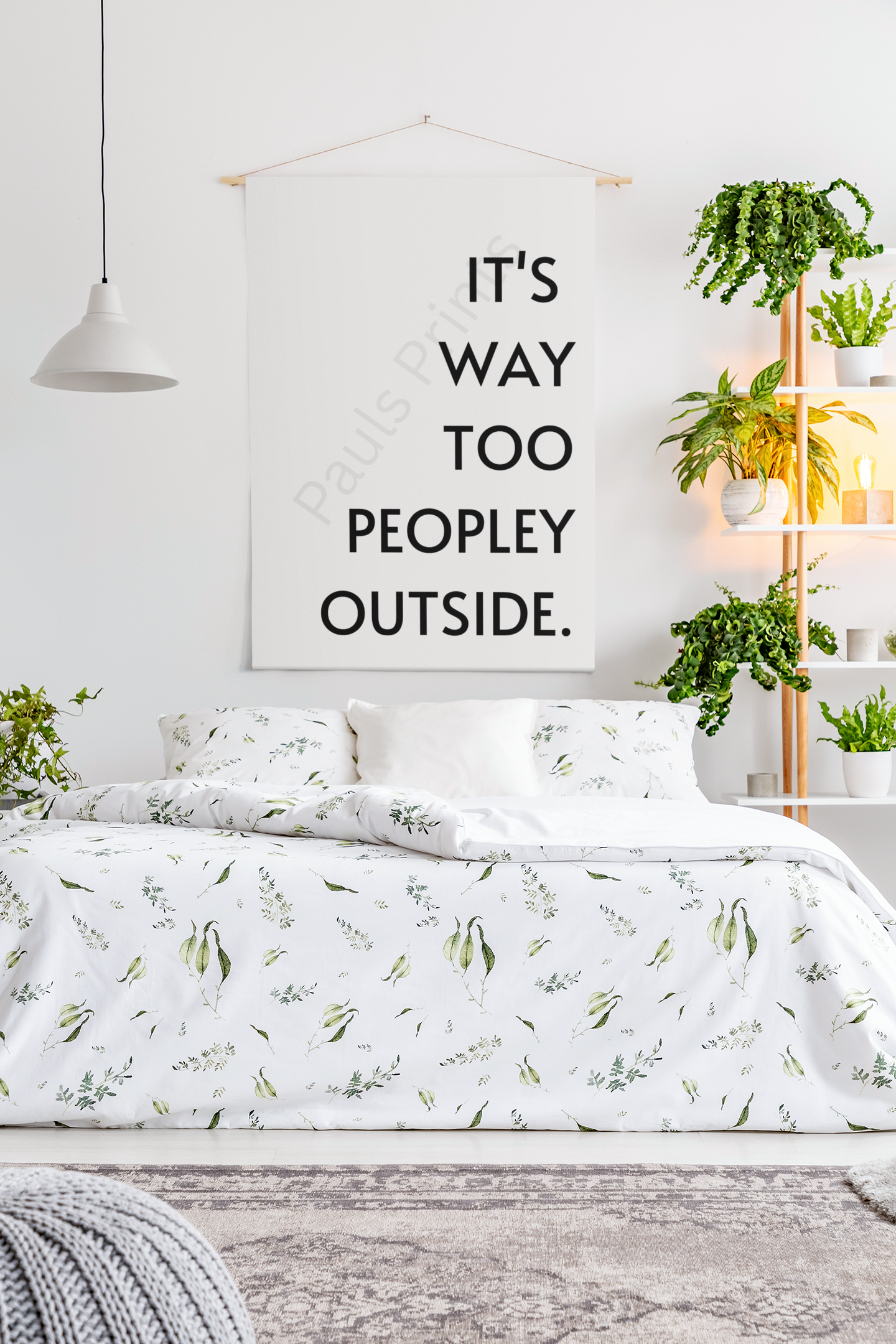Black framed print with the humorous quote “It’s Way Too Peopley Outside” hanging above a grey sofa in a modern living room.