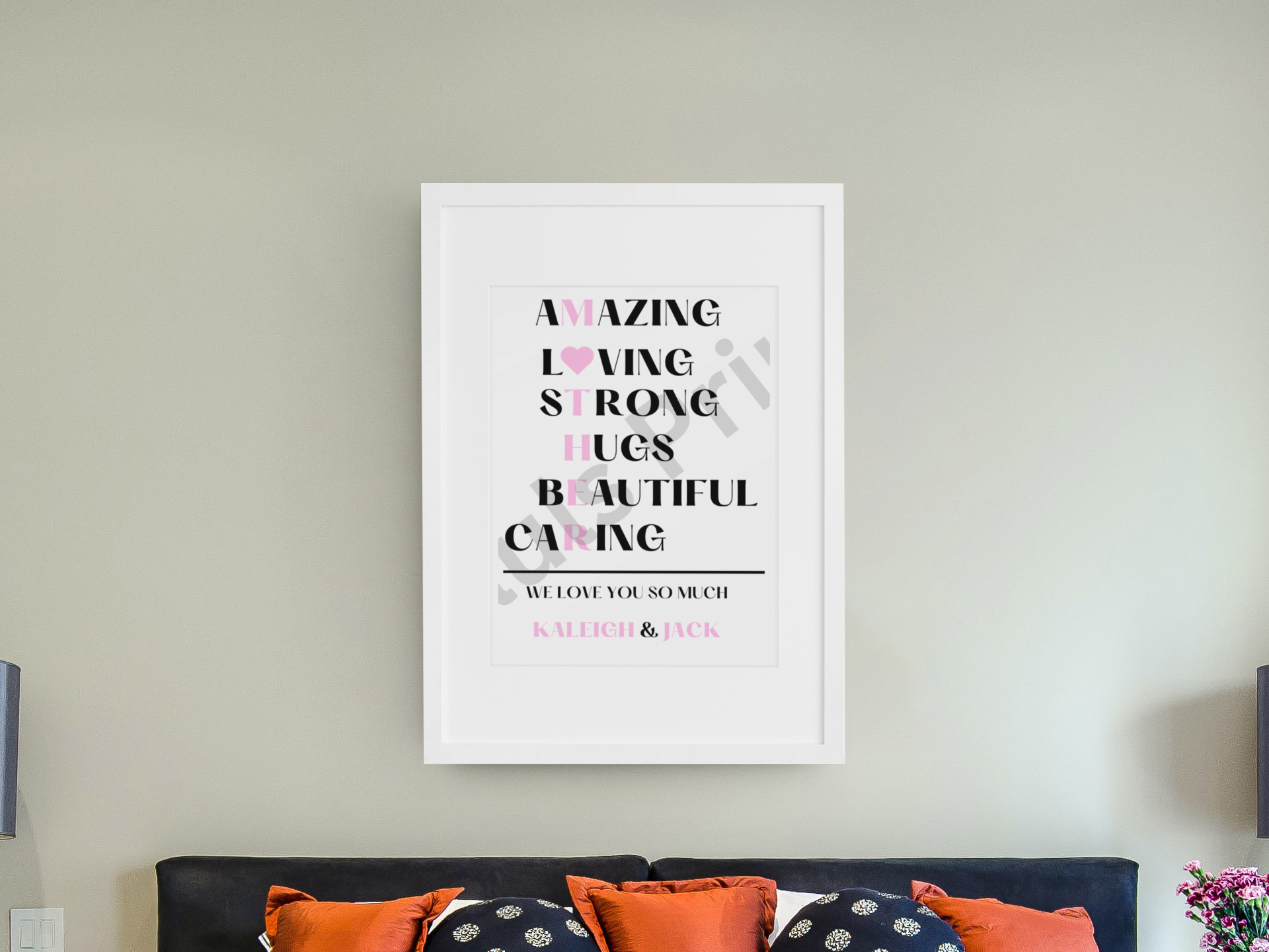 Personalised “MOTHER” traits wall print with bold black and pink text in a white frame, styled above a bed with orange and navy pillows.