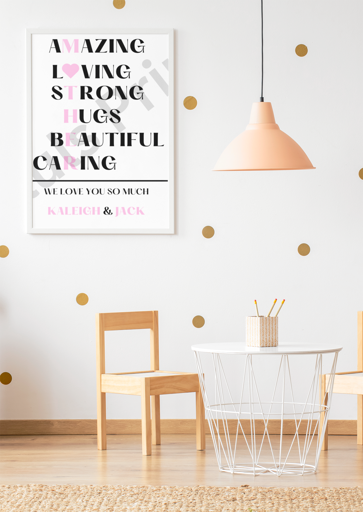 White frame “MOTHER” acrostic print with pink and black letters, styled with wooden furniture and gold polka-dot wallpaper in a children’s playroom.