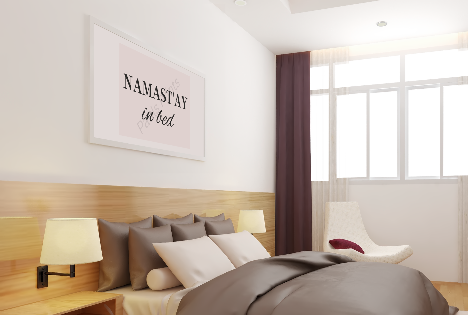 White-framed “Namast’ay in Bed” print on a wall above a bed with brown bedding and neutral pillows.