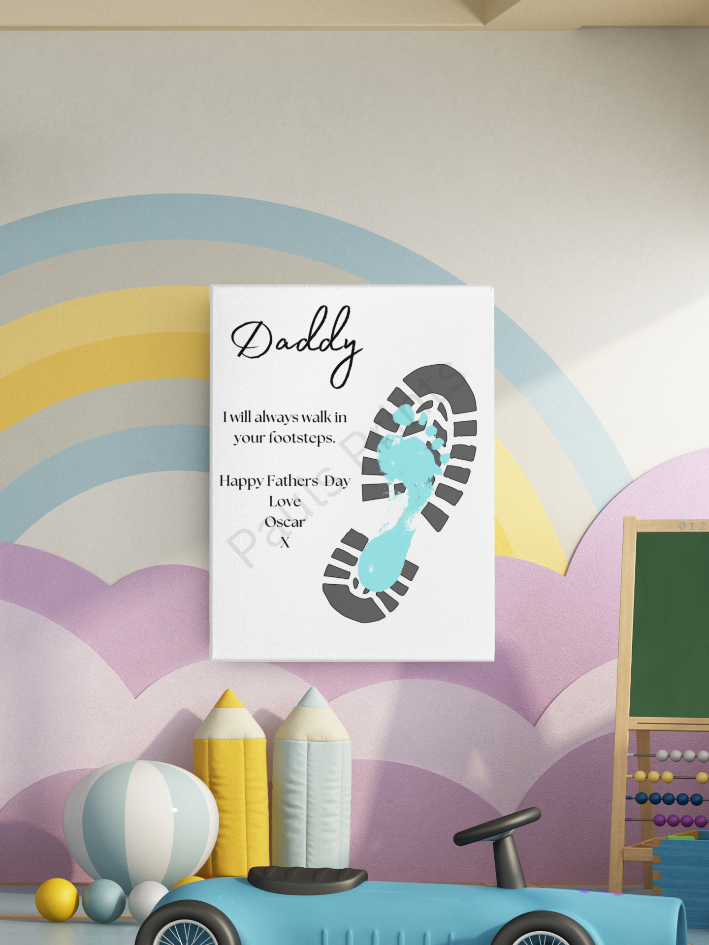 Canvas wall art featuring a blue child's footprint inside a black bootprint, displayed in a colourful children's playroom with rainbow wall mural and soft toys