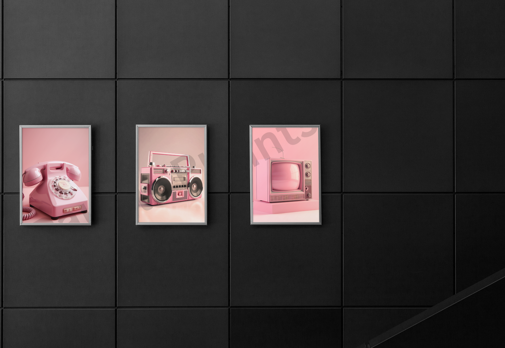 Three framed pink retro-themed prints of a rotary phone, boombox, and TV displayed against a sleek black wall.