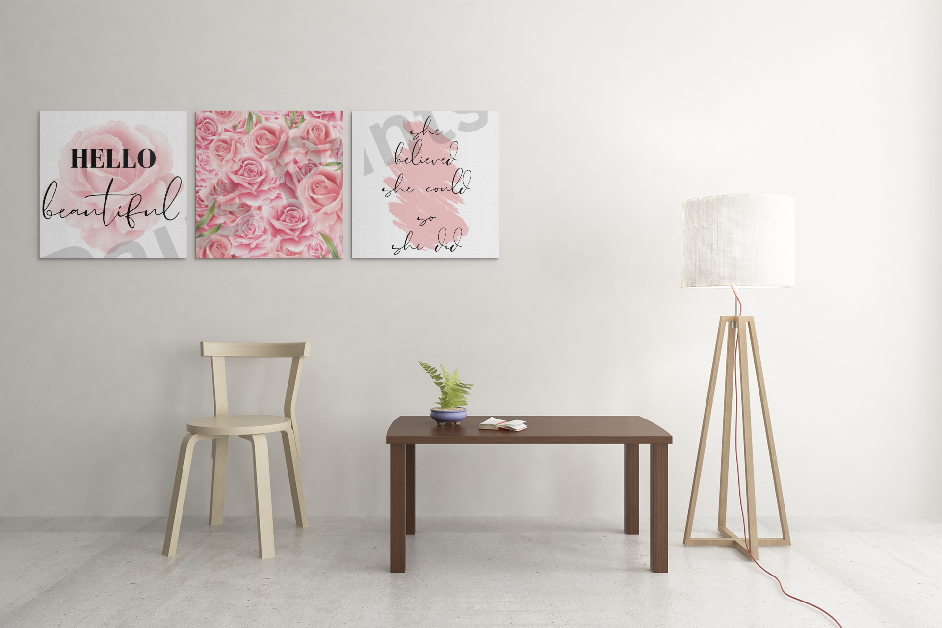 Three square canvas prints featuring a pink rose, a pink rose bouquet, and a motivational quote, displayed above a simple table and chair with a modern floor lamp.