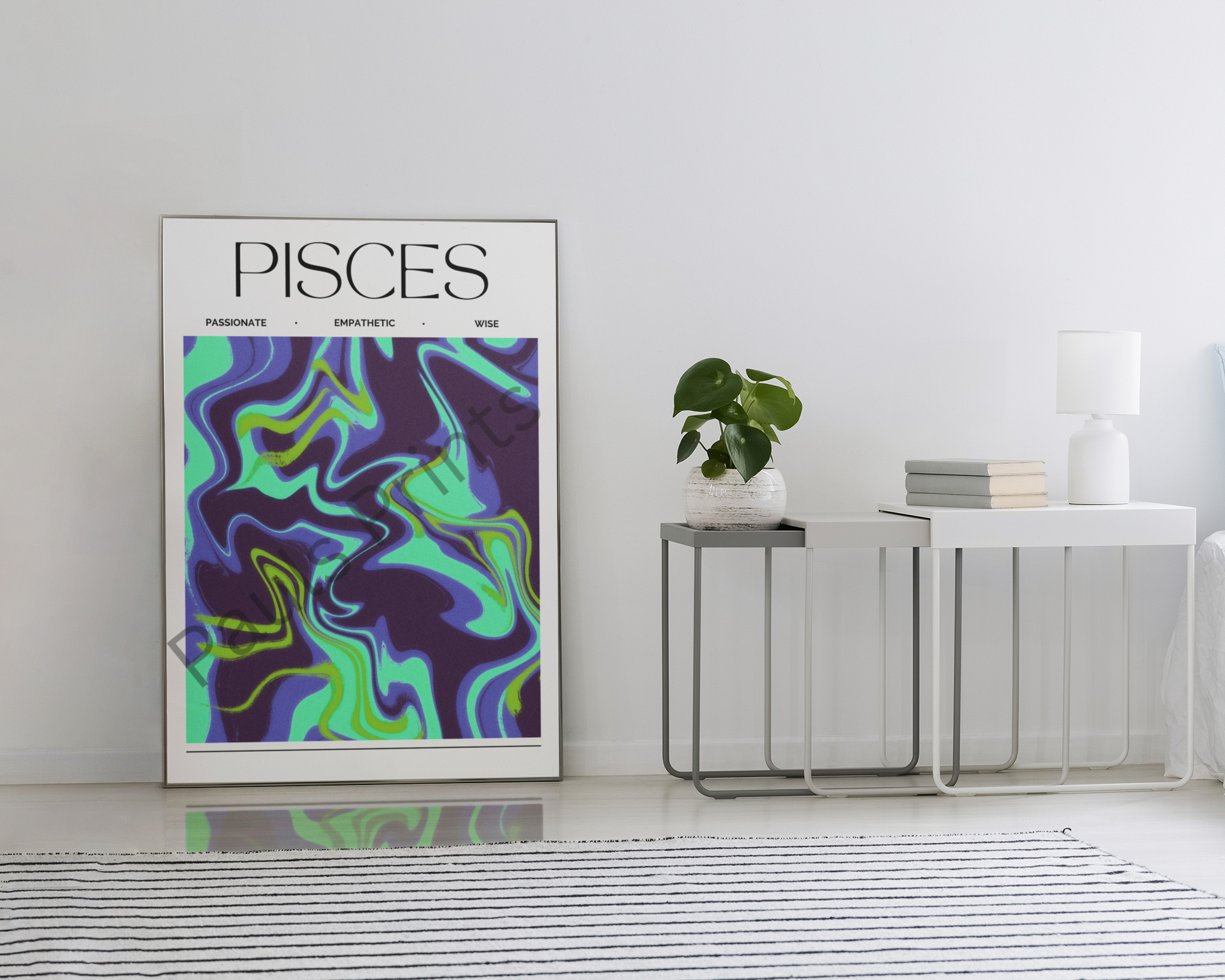 Oversized Pisces zodiac print leaning against a wall in a modern white interior, featuring bold purple and aqua swirls beside a minimalist side table.