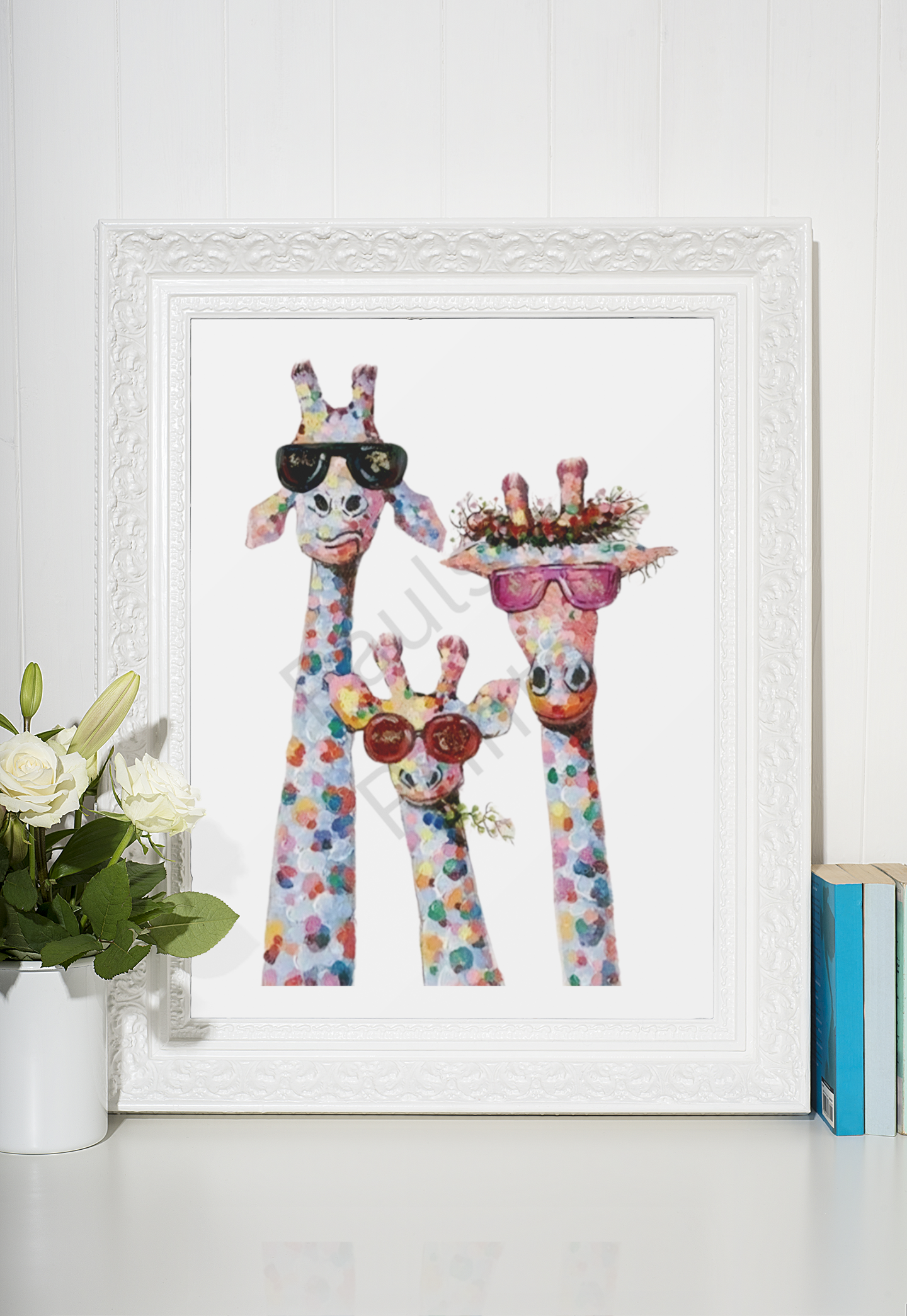 Three colourful giraffes in sunglasses and a floral headpiece, framed in ornate white, placed beside a vase of white roses and a stack of books.