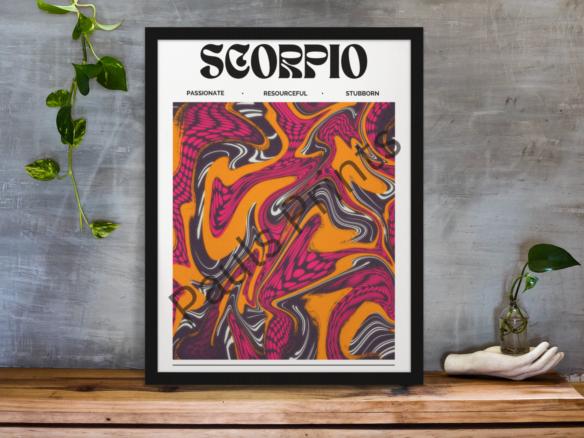 Large framed Scorpio zodiac poster featuring vivid orange and pink swirls, styled with plants and a sculpted hand on a rustic wooden shelf.