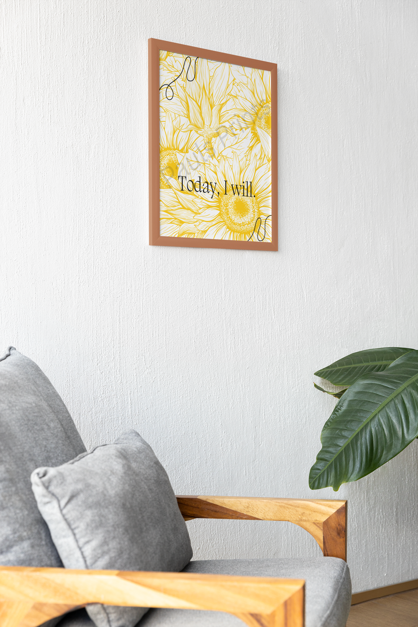 Wooden-framed sunflower print with “Today I will.” text, hanging above a grey armchair and large leafy plant.