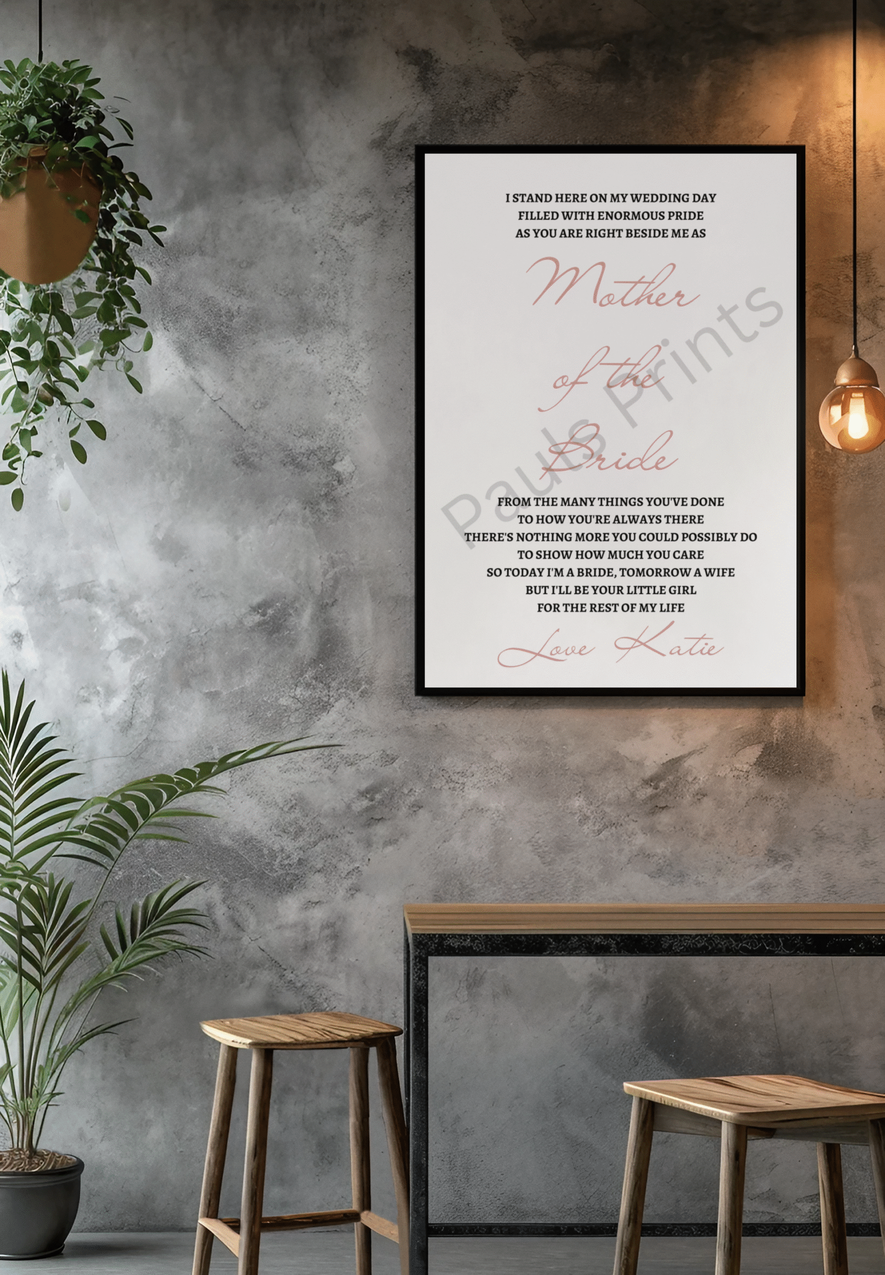 Romantic wedding day poem for the bride's mother displayed in a black frame on a textured concrete wall with a hanging light and greenery.