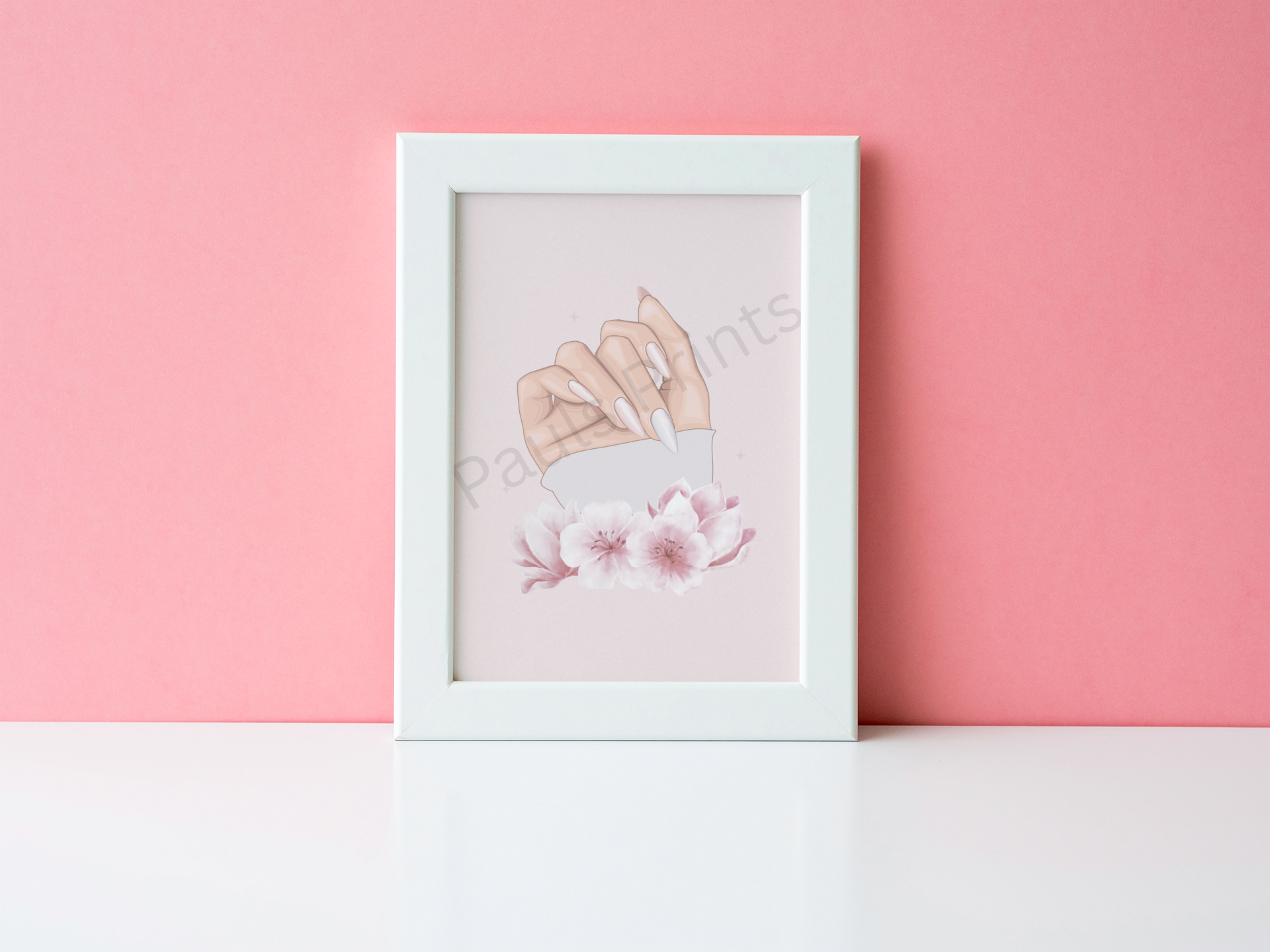 Minimalist print of a hand with long nails and pink blossoms, in a white frame against a pink wall.