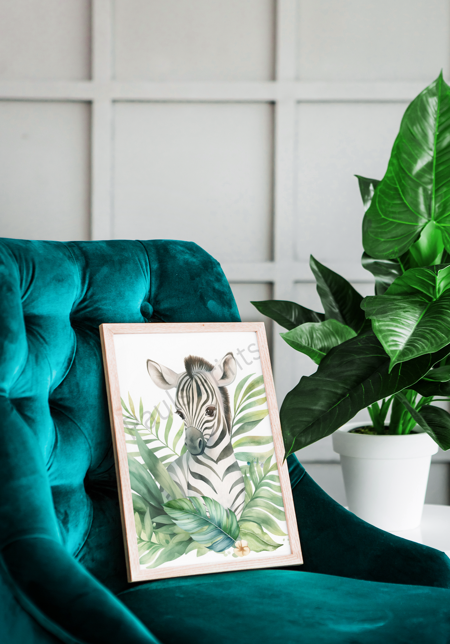 Framed zebra print leaning on a teal velvet armchair, surrounded by lush houseplants, creating a cosy jungle-inspired corner.