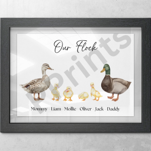 Personalised duck family print with black frame titled ‘Our Flock,’ hung on a concrete wall featuring names of each family member